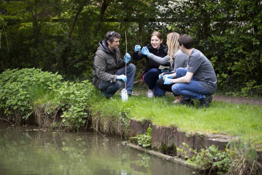 Earthwatch - people testing pond water