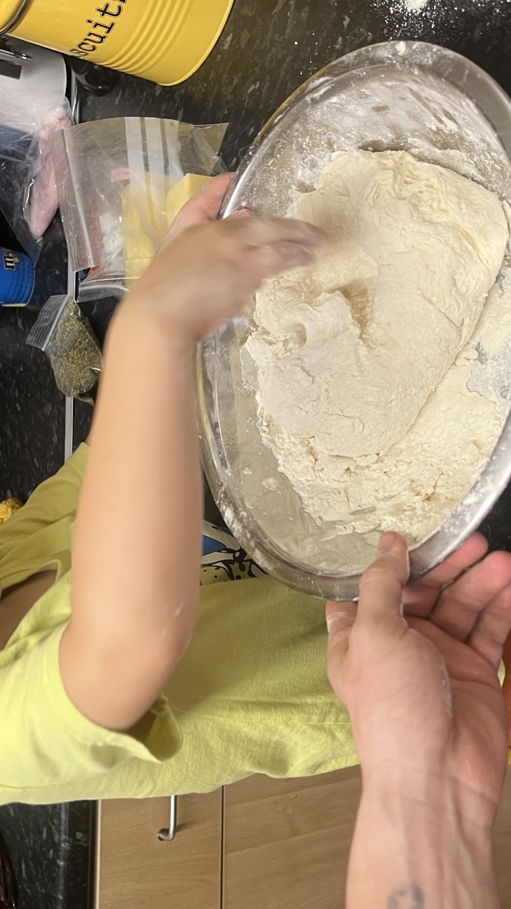 Boys with hands in a mixing bowl