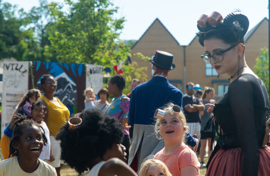 Children looking at festival performer
