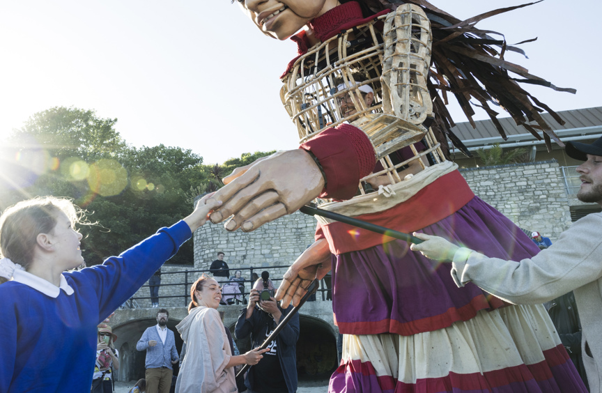 Child interacting with large puppet