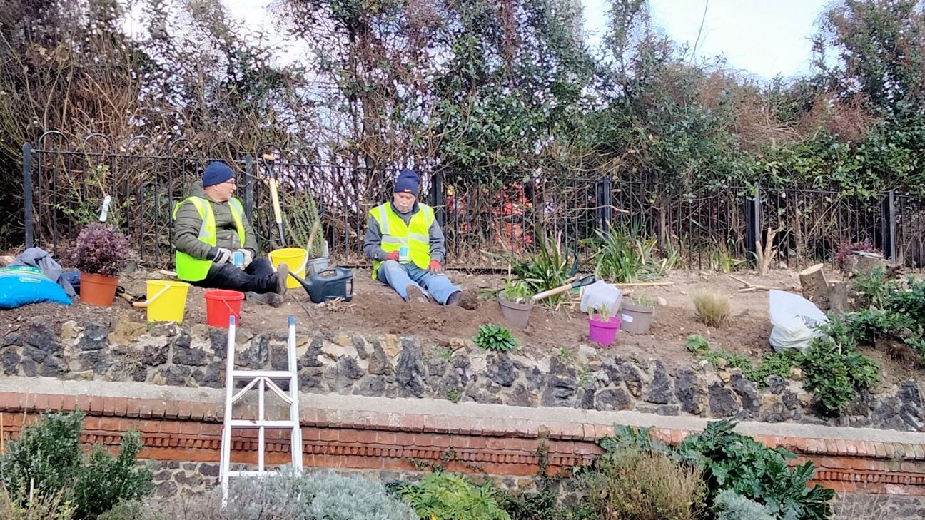 Two gardening volunteers taking a break with a cup of tea