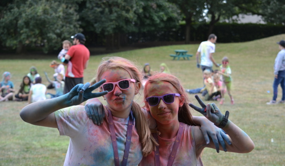 Celebration Church - two girls covered in paint posing in sunglasses 