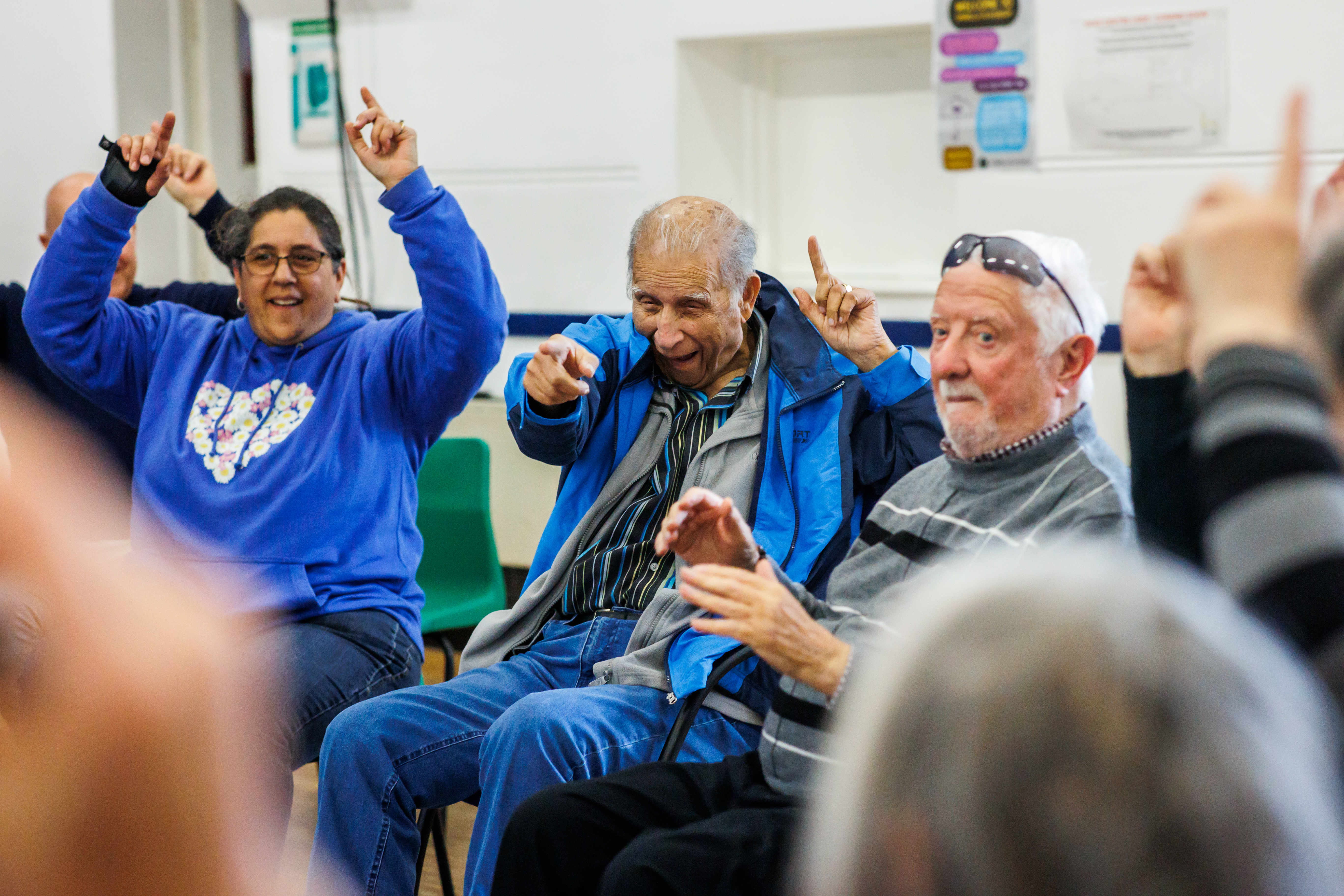 a woman and two men taking part in a workshop