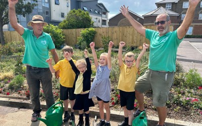 Wilderness to Wonderland - volunteers and children cheering in the garden