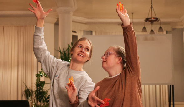 Two women dancing with arms in the air