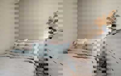 Bedroom with bed and chest of draws