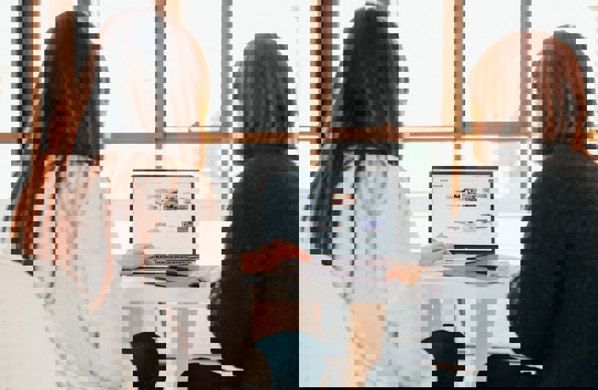Two women looking at a laptop screen